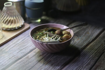 A bowl of noodle boat on the table