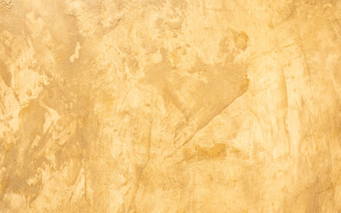 Abstract grunge decorative golden stucco wall with scratches, scuffs background. Art-stylized...