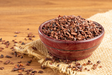Bowl with cocoa nibs on the table.