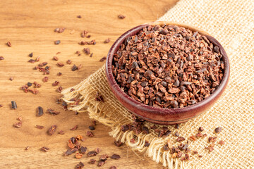 Bowl with cocoa nibs on the table.