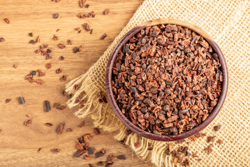 Bowl with cocoa nibs on the table.