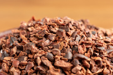 Bowl with cocoa nibs on the table.