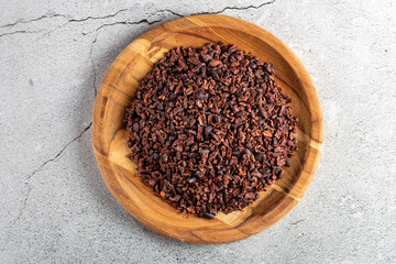 Bowl with cocoa nibs on the table.