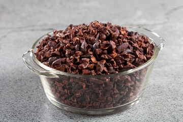 Bowl with cocoa nibs on the table.