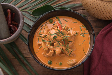 Thai curry red soup,Thailand tradition red curry with beef,pork or chicken menu in thai name is panaeng.Curry menu with coconut milk.Panaeng Curry on Wooden table