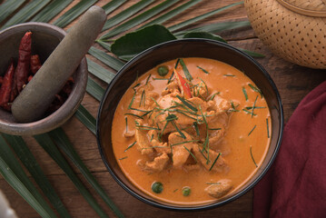 Thai curry red soup,Thailand tradition red curry with beef,pork or chicken menu in thai name is panaeng.Curry menu with coconut milk.Panaeng Curry on Wooden table