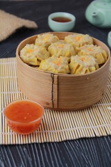 siomay dimsum filled with prawns, chicken, spring onions, on black background