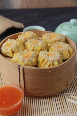 siomay dimsum filled with prawns, chicken, spring onions, on black background