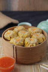 siomay dimsum filled with prawns, chicken, spring onions, on black background
