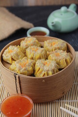 siomay dimsum filled with prawns, chicken, spring onions, on black background