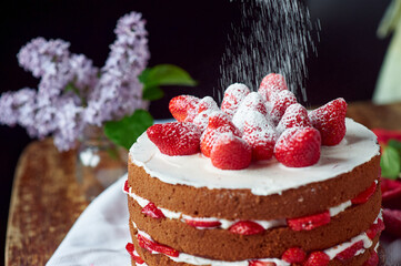 Victoria sponge cake with cream and strawberry on table with flower decor