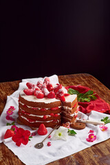 Victoria sponge cake with cream and strawberry on table with flower decor. Copy space