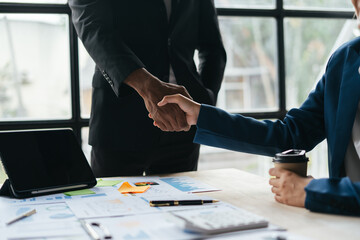 Business handshake for teamwork of business merger and acquisition,successful negotiate,hand shake,two businessman shake hand with partner to celebration partnership and business deal concept.