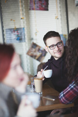 Happy young couple having a date at a cafe