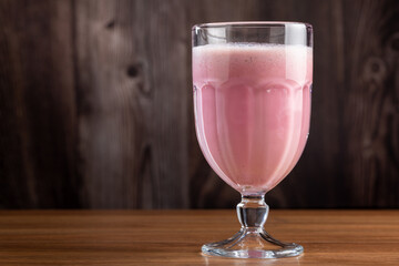 Glass with tasty strawberry smoothie.