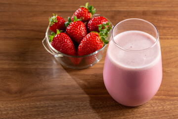 Glass with tasty strawberry smoothie.