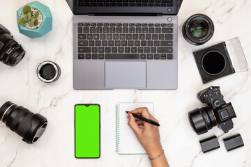 Layout of photographer work station working with smart phone with green screen with chroma key....