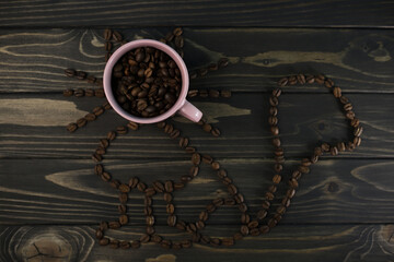 fragrant rich coffee beans of different varieties on a dark wooden surface in a pink coffee cup and saucer. for banners, flyers, splash screens, menu labels