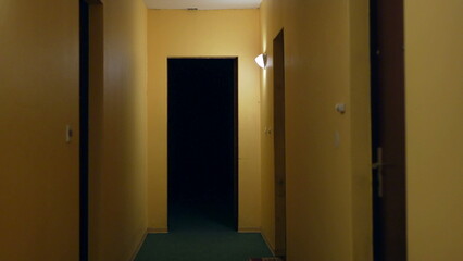 Walking in sketchy dark orange old corridor
