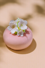 Obraz na płótnie Canvas Pink mousse cake with mirror glaze decorated with flowers