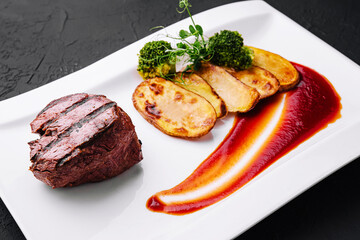 Appetizing fried beef steak with potatoes on plate
