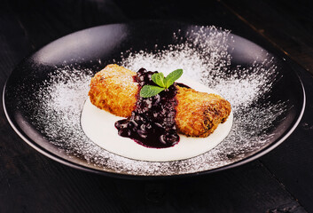 Puff pastry apple strudel with ice cream, served with cherry jam