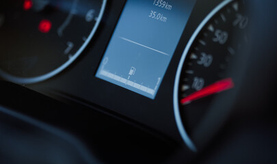 Fuel tank sign indicator on the dashboard display of a new car. Full gas tank during the rising prices.