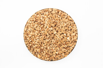 Closeup of korean red ginsengs on white background. Dried ginsengs coarse cuts. dehydrated ginsengs chips. medicines. herbs. herbal tea ingredients. wellness tea ingredients.