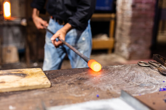 Glass blower at work in workshop in Murano, Italy