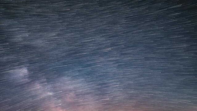 Startrails of stars in starry night sky with milky way galaxy trails Background Astronomy Time lapse