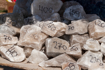 Pieces of rock salt with written on it the price in rubles. Natural rock salt. Sale of rock salt as...