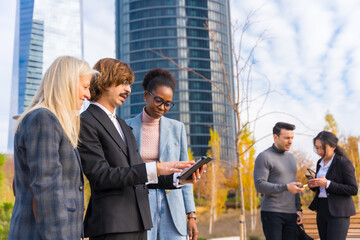 Multi-ethnic business people, business park, coworkers on their work break