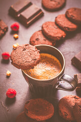 Cup of hot coffee and chocolate cookies for breakfast  or snack