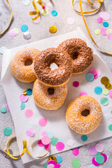 Krapfen, berliner or donuts with streamers, confetti  for carnival or party
