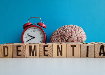 Alarm clock and word dementia and brain on table