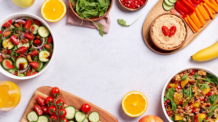 Vegan or veganuary feast with various salads ad healthy plates on light gray table
