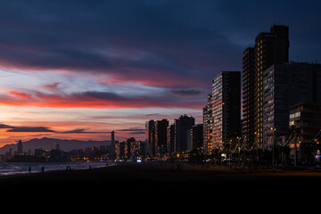View of the skyline at sunset in winter from the promenade beach of Benidorm on the Costa Blanca, Alicante, Spain.