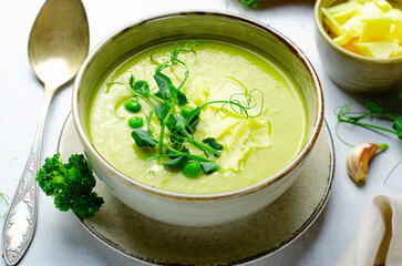 Pea Soup with Green Vegetables, Broccoli and Pea Sprounts with cheese on bright backround