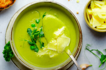 Pea Soup with Green Vegetables, Broccoli and Pea Sprounts with cheese on bright backround