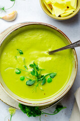 Pea Soup with Green Vegetables, Broccoli and Pea Sprounts with cheese on bright backround