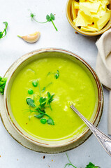Pea Soup with Green Vegetables, Broccoli and Pea Sprounts with cheese on bright backround