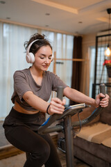 Fototapeta na wymiar One woman young training on Indoor Cycling stationary Exercise Bike