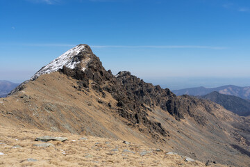 mountain landscape with rocky snowy peak and blue sky