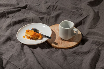 Leftover cake and coffee in bed. Close-up.