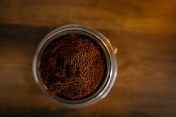 An interesting photo of ground coffee in a coffee maker.  Artistic noise and grain