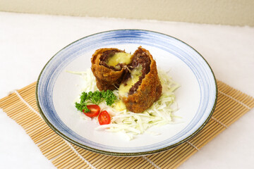 side dish of minced beef meat with melted cheesy on white plate placed on white table