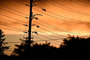 Electric pole in awsome fiery sunset in the city 