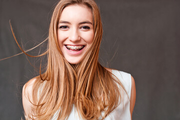 Fototapeta premium cheerful girl smiling with braces, hair motion