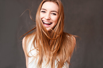 laughing girl wearing braces, cheerful portrait