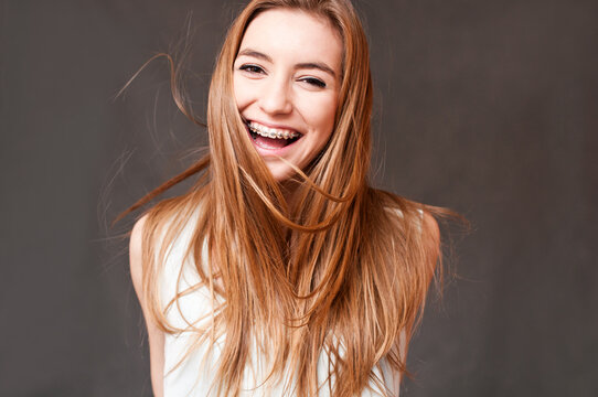 laughing girl wearing braces, cheerful portrait